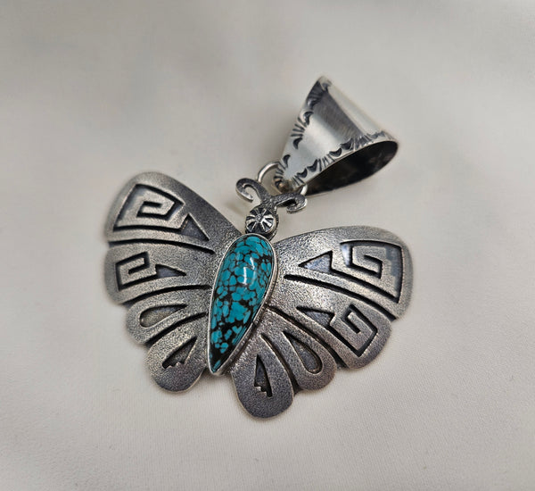 Silver engraved butterfly pendant for necklaces with a webbed turquoise stone